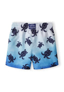 Boys board shorts in light blue with turtle print, back view, featuring a drawstring waistband.