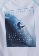 Boys short sleeve rash top in white with water sports print, front view.