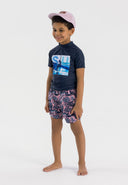 Boys short sleeve navy rash top with decorative print, front view.