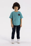 Boys navy cargo trousers with elastic waistband, front view, featuring leg pockets.