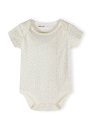 Cream short sleeve baby bodysuit with subtle multicolor safari-inspired dot pattern and envelope neckline design