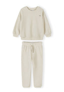 Cream-colored boys tracksuit with sweatshirt and joggers featuring a simple, comfortable design for kids.