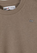 Close-up of beige kids sweatshirt with ribbed collar and small embroidered animal design near chest pocket.