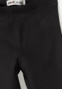 Close-up of slim fit black leggings for girls featuring a smooth elasticated waistband and soft fabric design