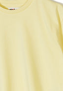 Close-up of soft yellow cotton t-shirt with crew neck and short sleeves, designed for kids’ comfortable wear.