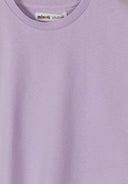 Close-up of soft lilac cotton fabric with crew neck and simple design for comfortable kids' wear.