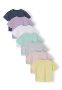 Set of seven multicoloured girls cotton t-shirts with crew neck and short sleeves, showcasing simple design and soft fabric.