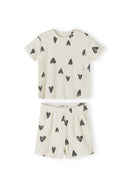 Close-up detail of cream ribbed fabric texture showing hand-drawn black hearts print pattern and crew neckline