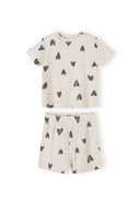 Single cream ribbed pyjama set with black hearts print showing short-sleeved top and matching shorts laid flat on white background