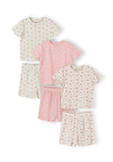 Three pyjama sets arranged on white background showing floral print tops and shorts in pink and cream colours
