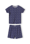 Navy pyjama set with white floral print showing short sleeve top and matching shorts with scalloped edges on white background