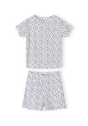 Navy pyjama set with white floral print showing short sleeve top and matching shorts with scalloped edges on white background