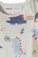 Close-up of soft cotton bodysuit with playful blue and red dinosaur design and positive words like cool and awesome.