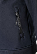 Detail of a black softshell jacket featuring a zippered pocket.