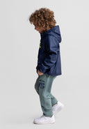 Child wearing navy blue waterproof parka jacket with hood, showing stylish and functional kids outdoor design.