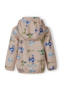 Back view of a kids softshell jacket with colorful aeroplane design on sand background