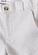 Detail of boys tailored cotton suit shorts in stone color with a button and striped pattern.