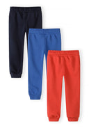 Set of three boys joggers in navy blue, royal blue, and red with elastic waists and side pockets, stylish kidswear design.