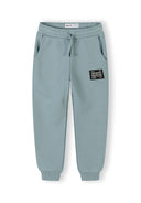 Kids sweatpants with elastic waistband, drawstring, side pockets, and patch detail for casual comfort and stylish design.