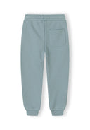 Back view of blue kids sweatpants with elastic waistband and single back pocket in soft fabric design