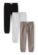 Three boys joggers in black, grey, and beige with drawstrings and pockets, designed for comfort and style.
