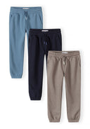 Three boys joggers in blue, beige, and navy with elastic waistbands and drawstring for comfortable fit and classic design.