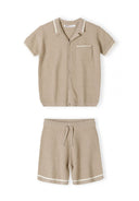 Boys knitted polo shirt with lapel collar and beige shorts, front view.