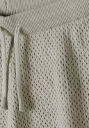 Detail of boys' hellkhaki knitted shorts with elastic waistband and drawstring.