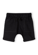 Black cotton jersey shorts for boys with an elastic waist and front pockets, designed for comfort and everyday wear.