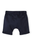 Back view of navy blue cotton jersey kids shorts with elastic waistband and rolled hems design