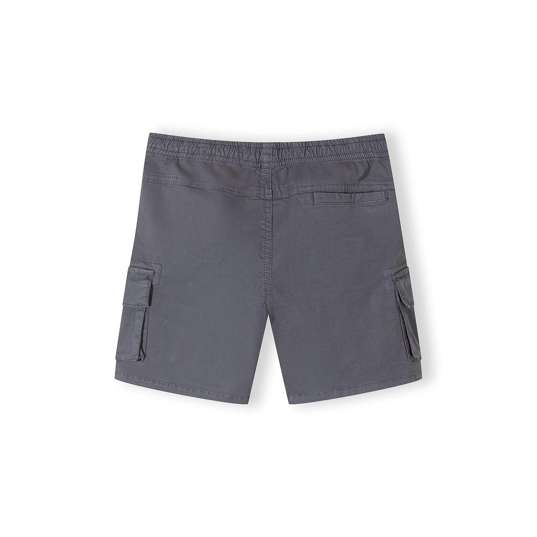 Single pair of camel brown combat shorts laid flat showing front view with cargo pockets, drawstring waist and utility styling on white background