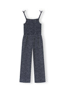 Girls black sleeveless jumpsuit with delicate all-over print and slim shoulder straps showcasing unique design.