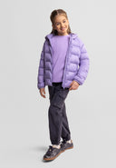 Young girl wearing a lightweight purple nylon wind-resistant jacket with casual black pants and sneakers smiling confidently