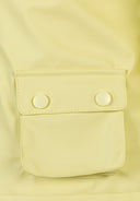 Detail of a bright yellow waterproof jacket with a snap-button pocket.