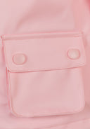 Detail of a pink waterproof jacket with a snap button pocket.