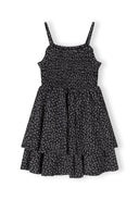 Girls black floral summer dress with adjustable straps, front view featuring a ruched bodice.
