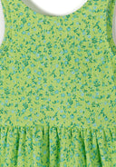 Detail of a girls' sleeveless floral dress in green with a tiered skirt.