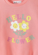 Close-up of pink girls sweatshirt with colorful floral design and cheerful flower illustrations on front
