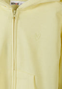 Close-up of a yellow zip-up hoodie with a small heart-shaped stitched design on the chest.