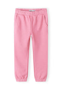 Pink girls joggers with elastic waistband and side pockets featuring a comfortable and stylish design for kids.