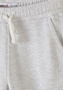 Close-up of soft grey marl joggers for girls featuring a drawstring and comfortable elastic waistband design.