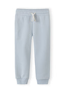 Pastel light blue girls joggers with elastic waistband and drawstring showcasing simple, comfortable design for kids.
