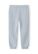 Light blue jogger pants for girls with elastic waistband and ribbed cuffs, featuring a comfortable and simple design.