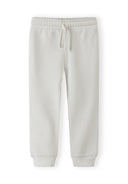 Soft white joggers for girls with elastic waistband and drawstring, featuring a comfortable and stylish design.