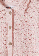 Soft pink knit fabric with delicate pointelle design and wooden buttons on kidswear cardigan