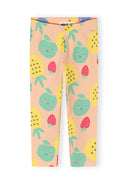 Girls peach capri leggings with playful fruit print featuring smiling apples, pineapples, and strawberries design.