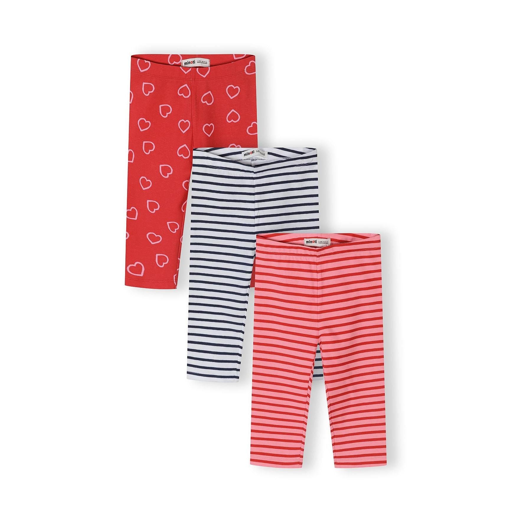 Three capri leggings laid flat showing red heart print, navy blue striped, and coral pink striped designs on white background