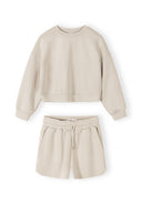 Beige girls sweatshirt and shorts set with crew neck, long sleeves, and elasticated waist showcasing a clean, modern design.