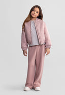 Young girl wearing pink wide leg joggers and matching jacket showcasing comfortable kids fashion design