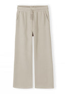 Beige wide leg jogger pants with elastic waistband and drawstring, featuring a relaxed fit and side pockets design.